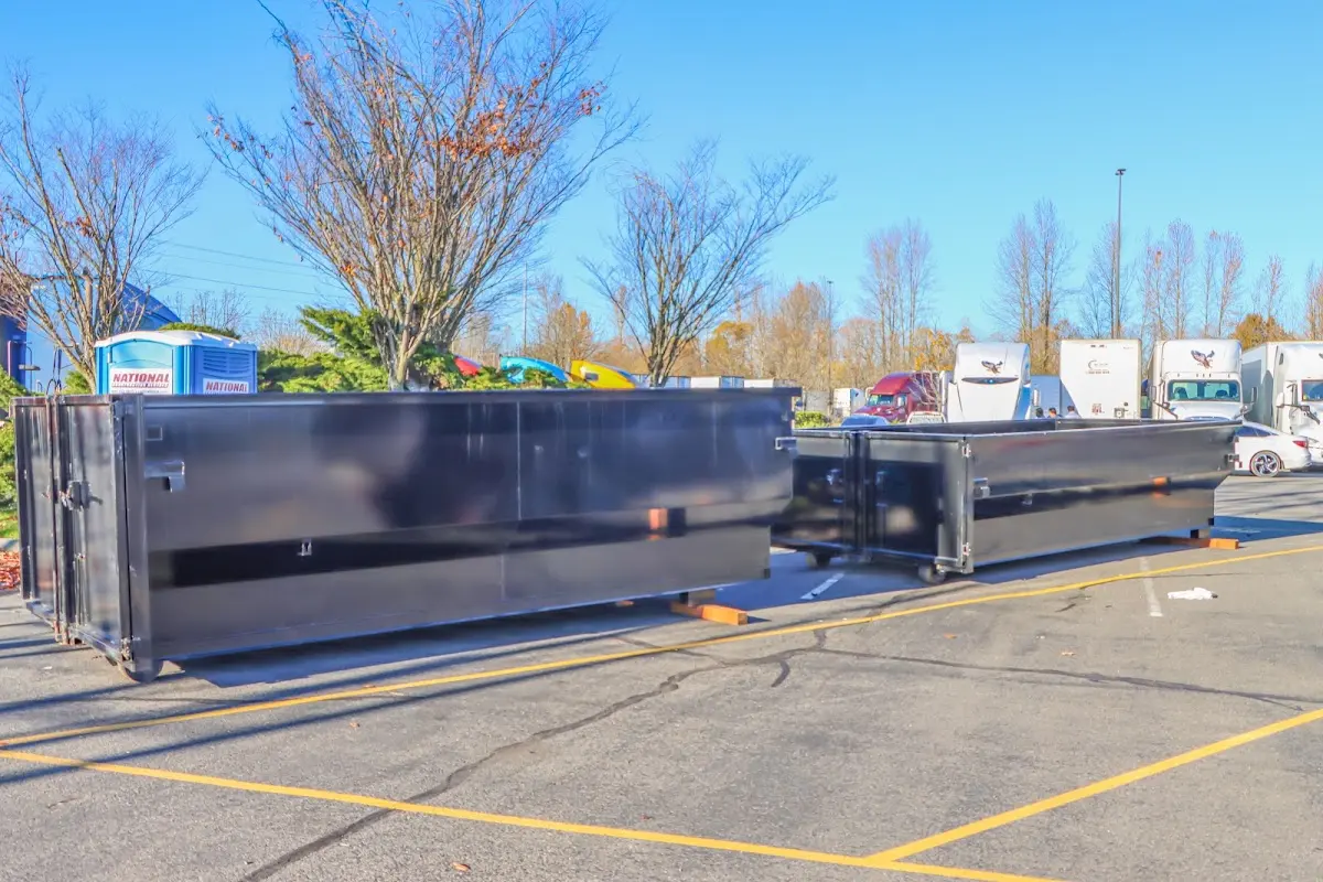 Professional dumpster rental service with roll-off container on residential driveway in Bensenville